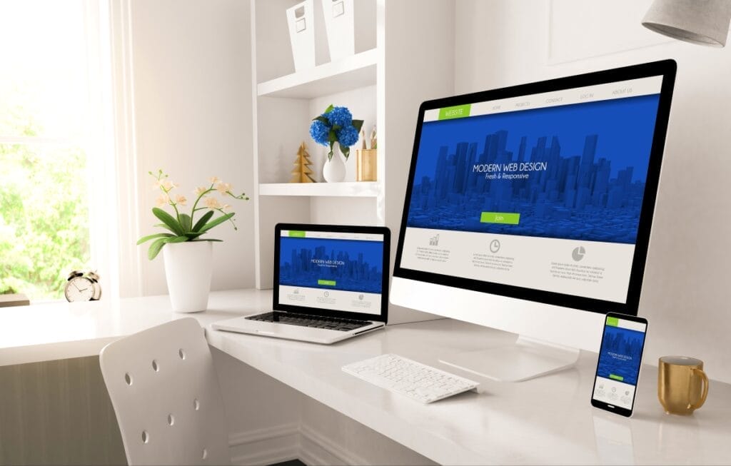 Desktop monitor, laptop, and phone with responsive homepage