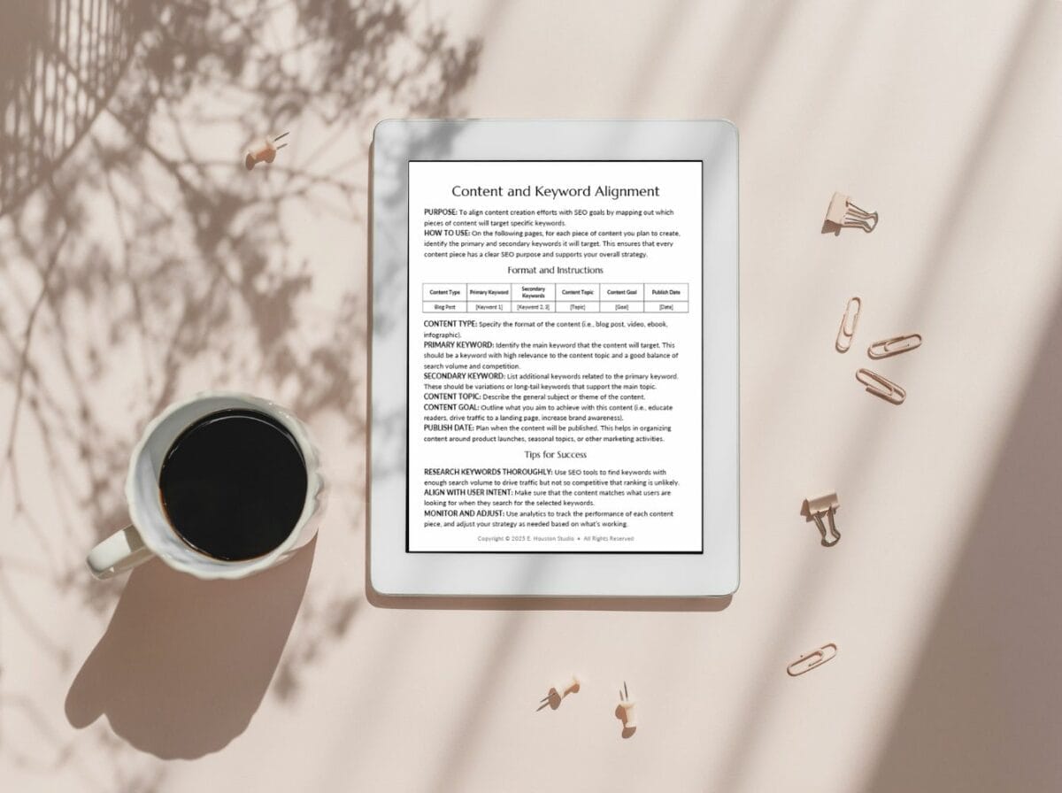 A tablet displaying a document titled "Content and Keyword Alignment" lies on a pink surface next to a cup of black coffee and scattered paper clips and binder clips.