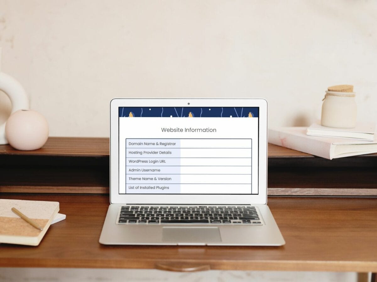 A laptop on a wooden desk displays a table titled "Website Information" with website-related details listed in rows.